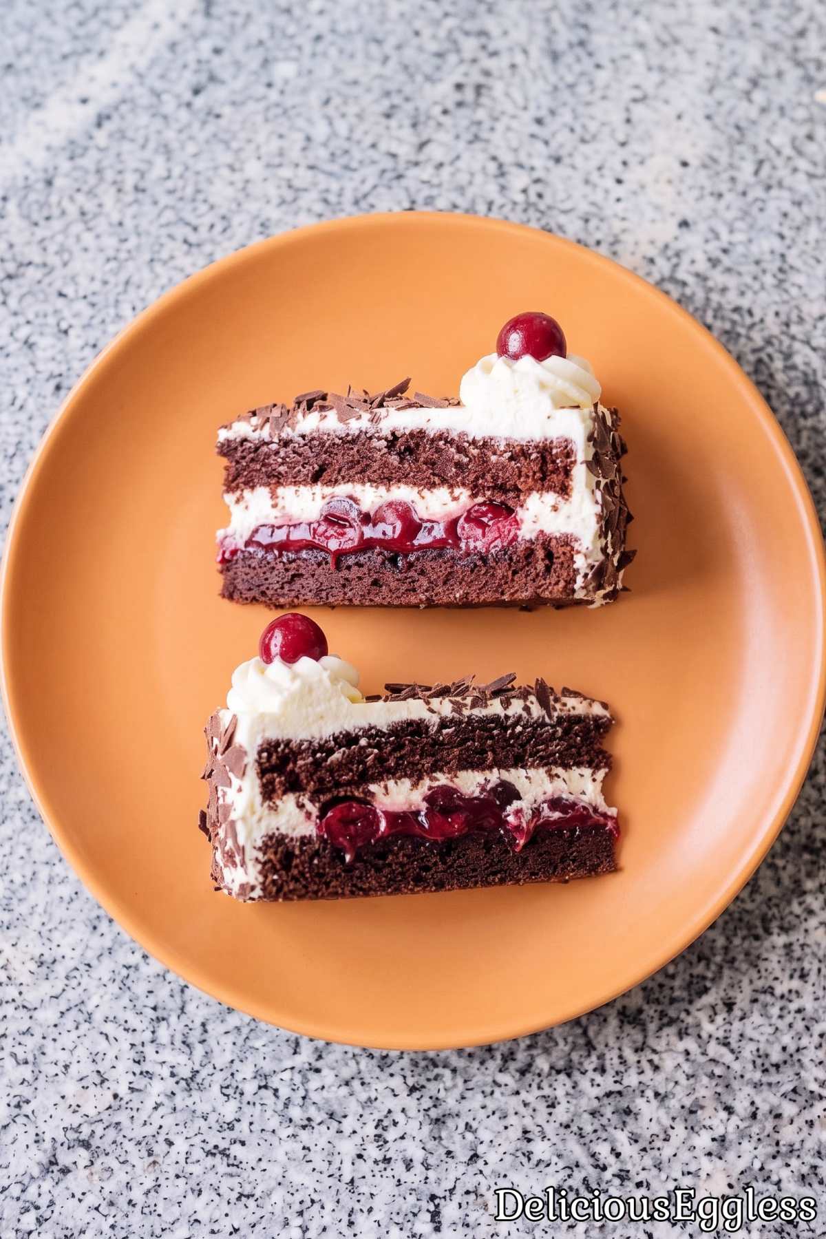 Classic eggless black forest cake with cherries.