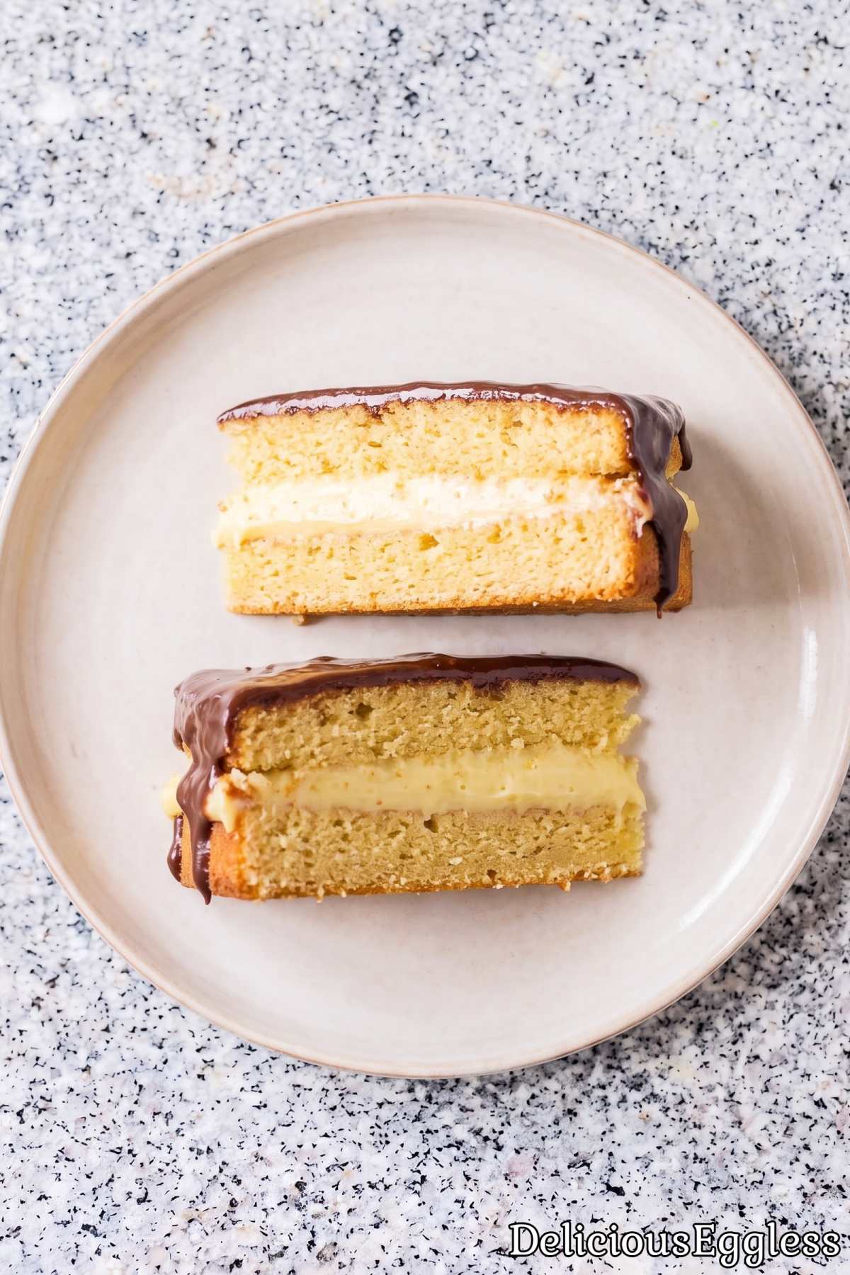 Rich eggless Boston cream pie on a plate.