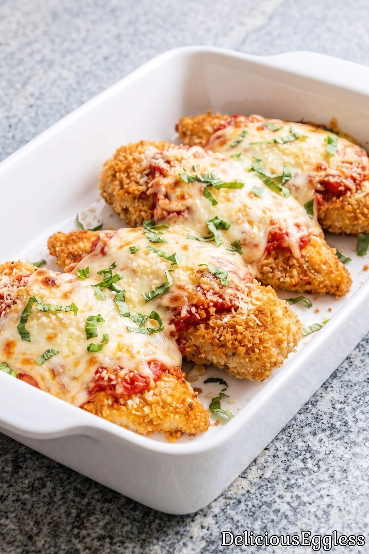 Melted cheese on eggless chicken parmesan
