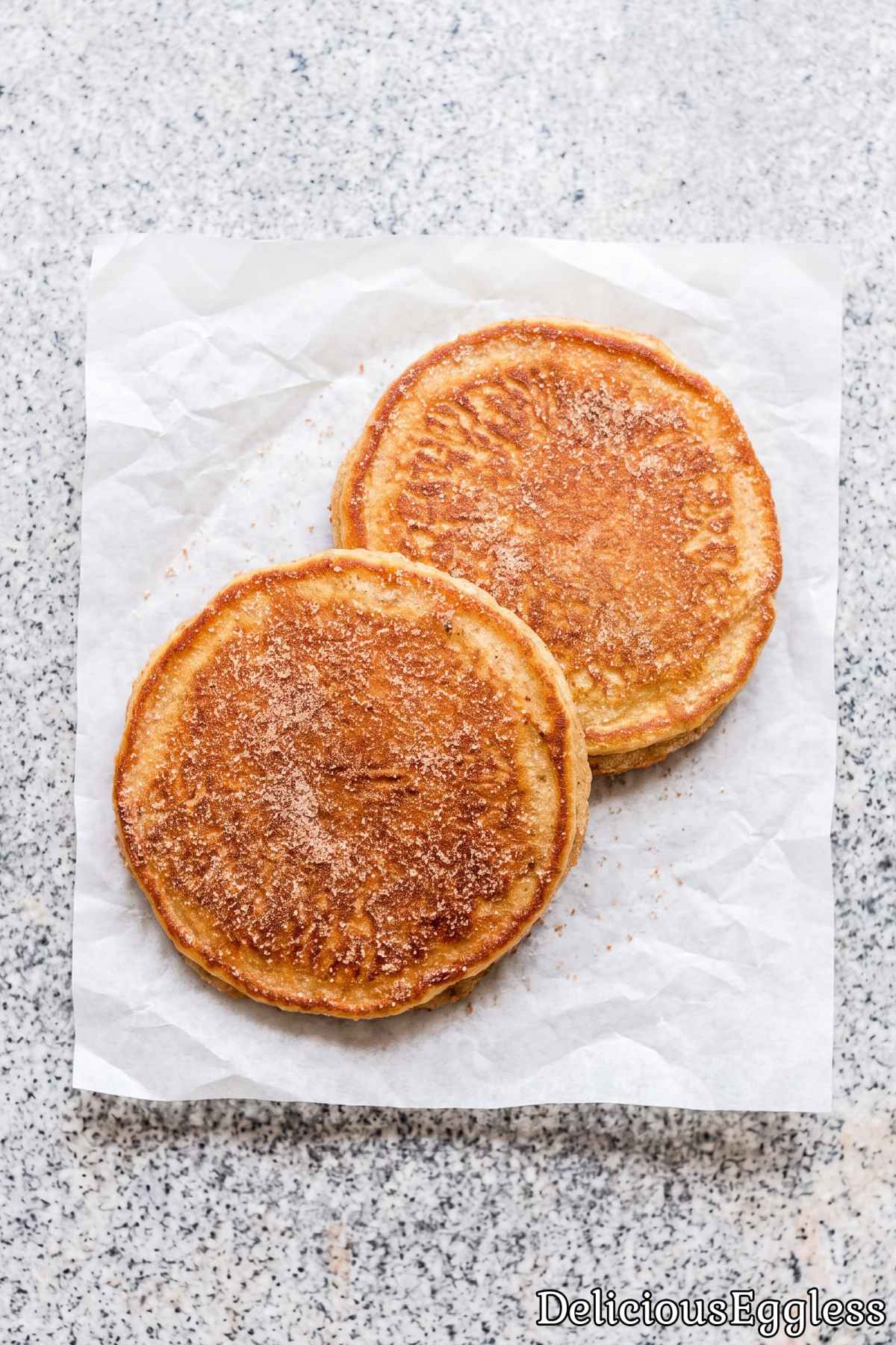 Stack of golden eggless churro pancakes