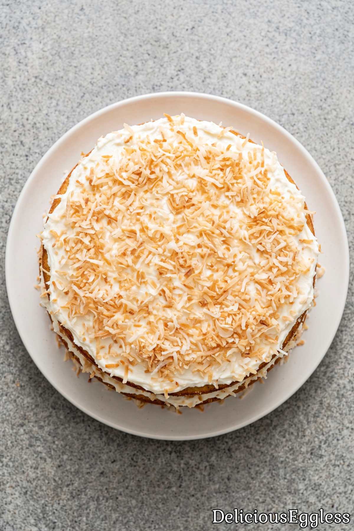 Slice of eggless coconut layer cake