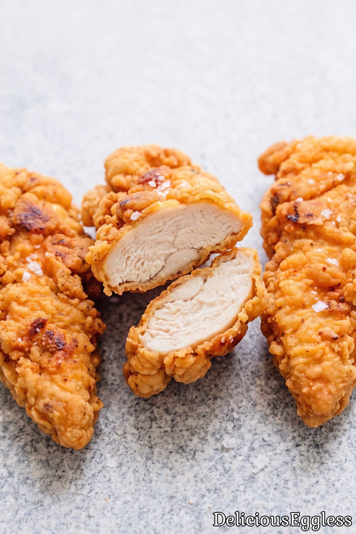 Homemade eggless chicken strips on a board