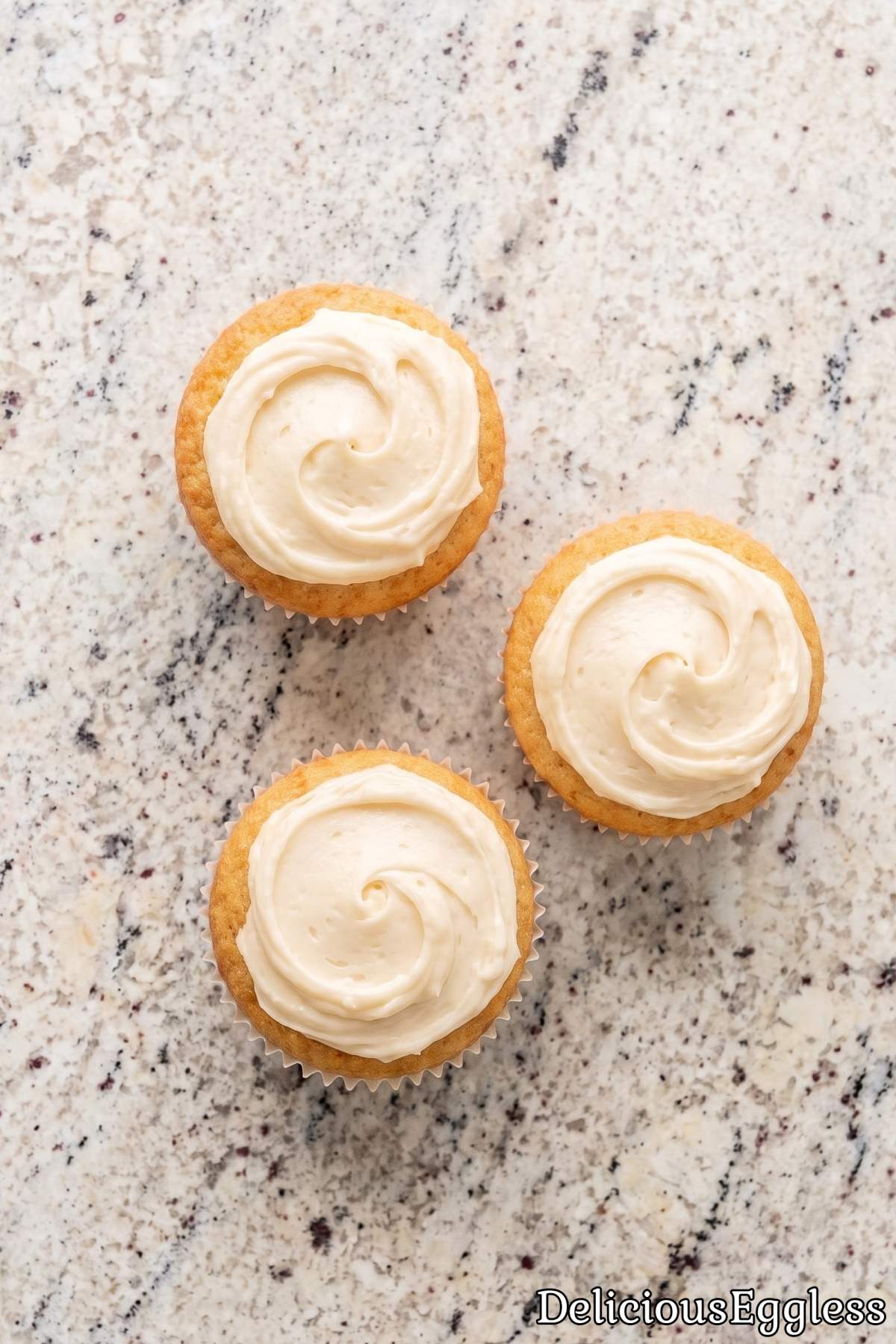 Fresh eggless vanilla cupcakes with frosting