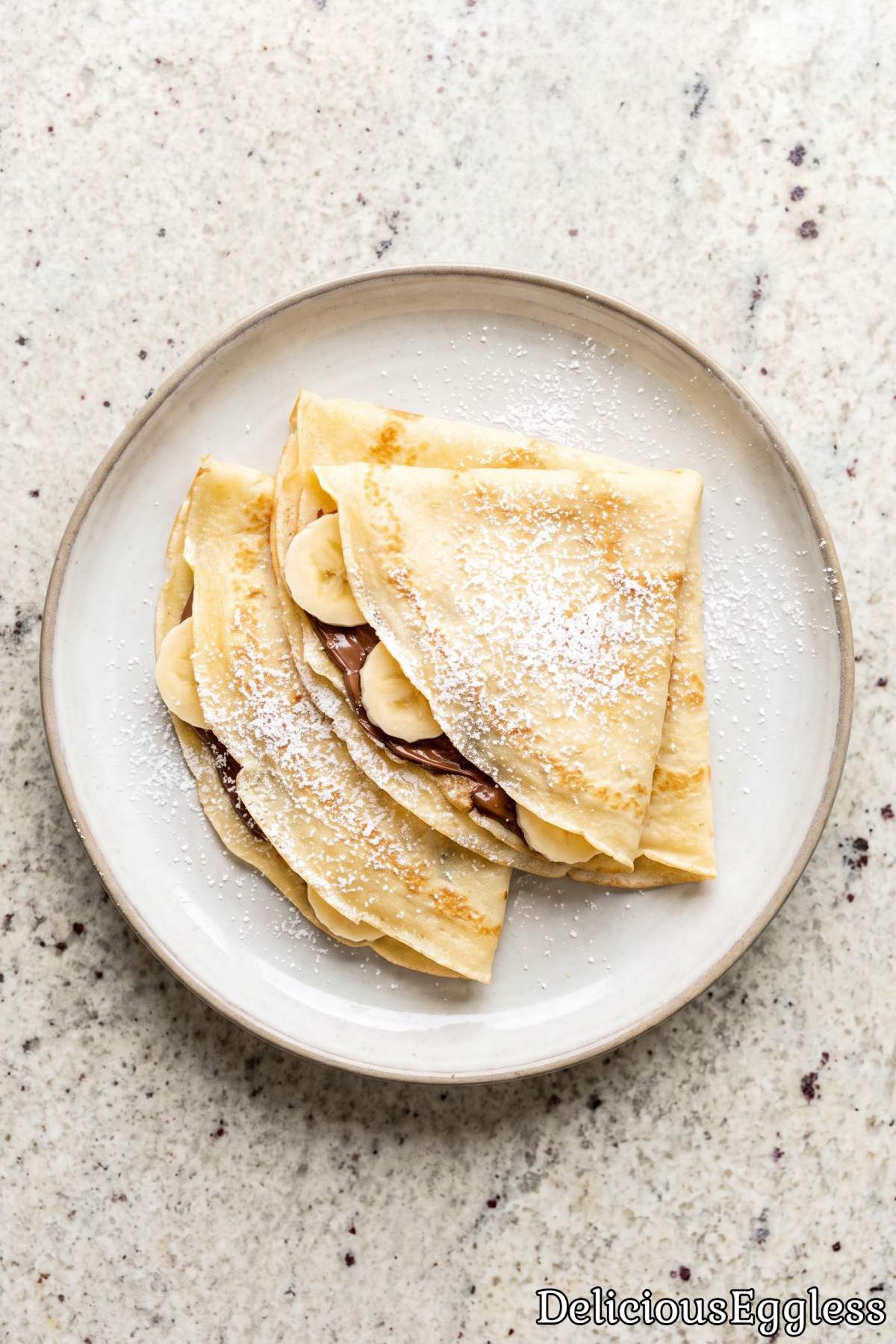 Warm homemade eggless crepes on a plate