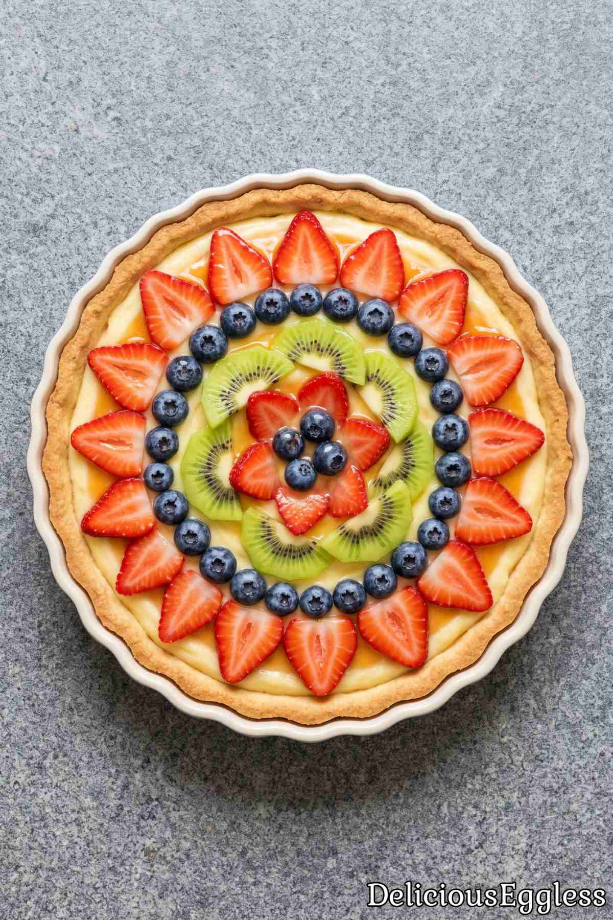 Sweet eggless tart topped with fresh fruits.