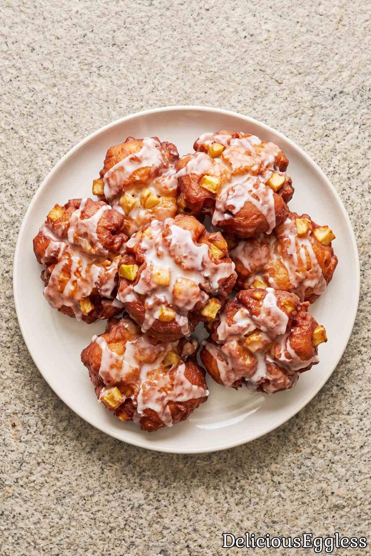 Golden eggless apple fritters with sweet glaze