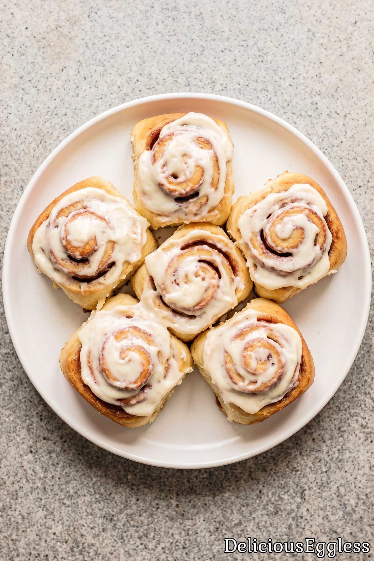Gooey eggless cinnamon rolls on a plate