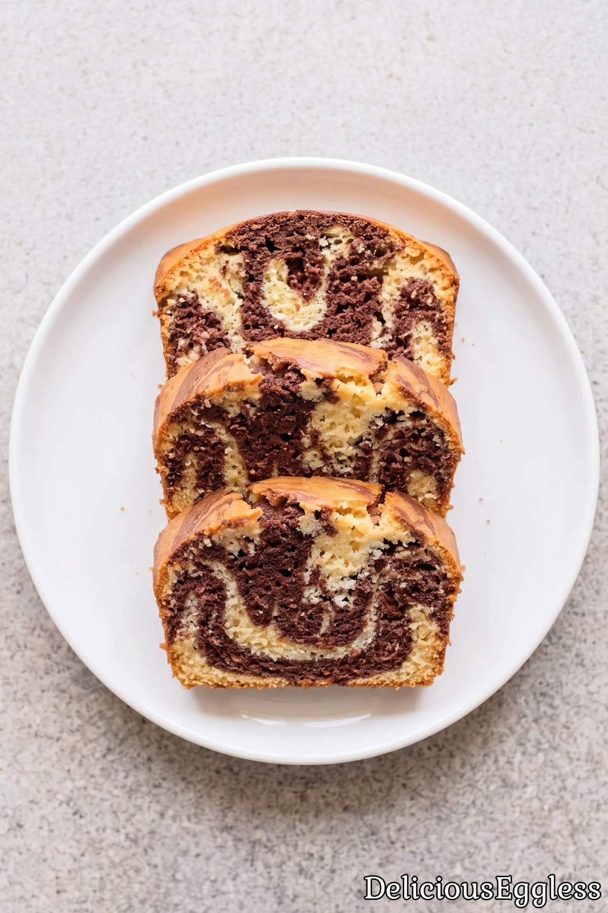 Slices of moist eggless marble loaf cake.