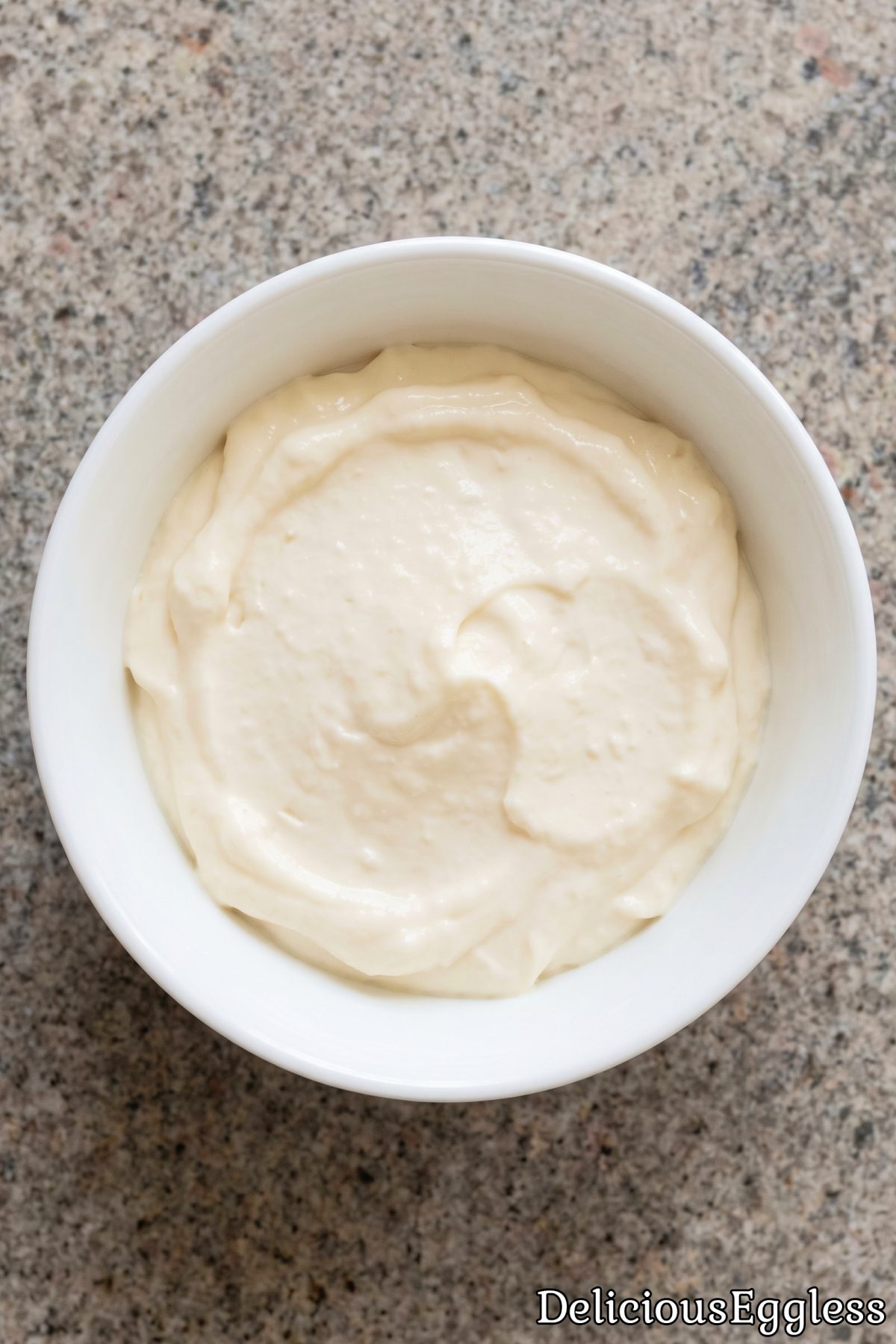 Smooth eggless mayo on a spoon