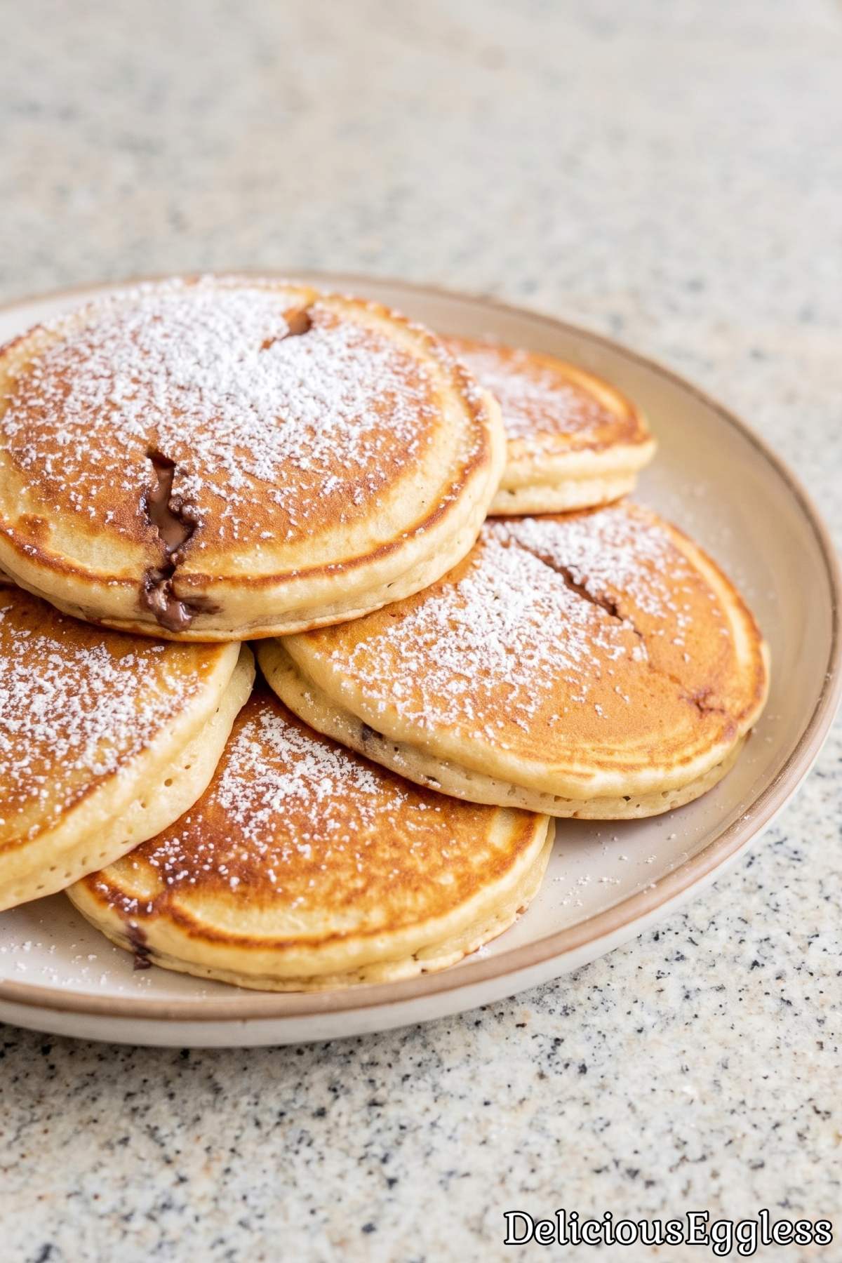 Stack of warm eggless Nutella stuffed pancakes