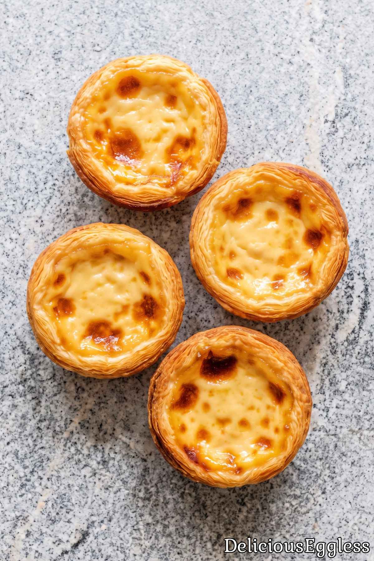 Creamy eggless Portuguese custard tarts on plate