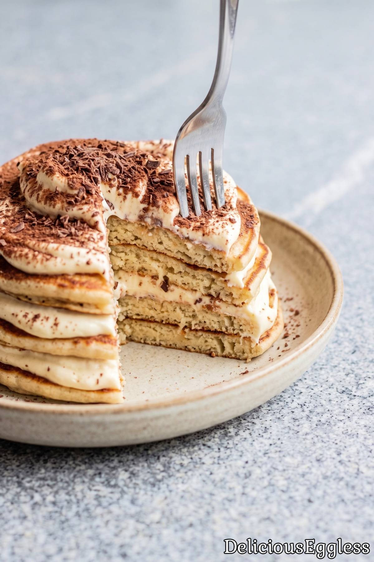 Eggless tiramisu pancakes topped with cream